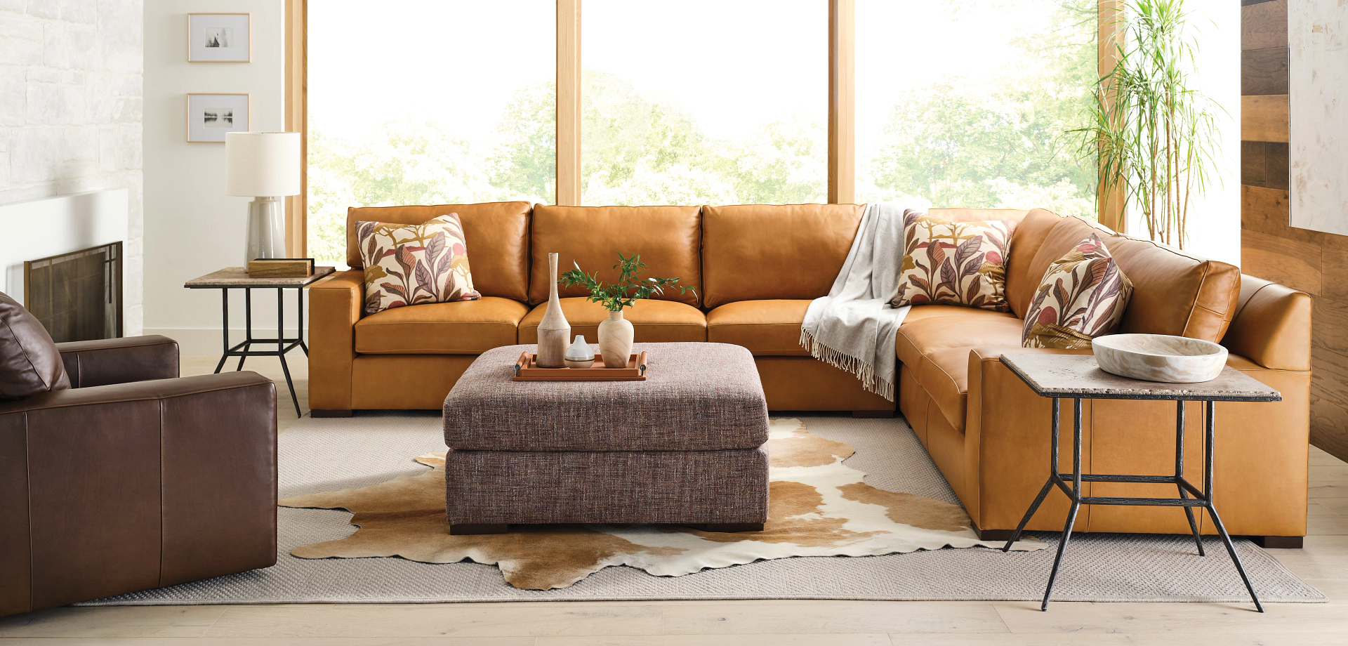 Large brown leather sectional in living room  